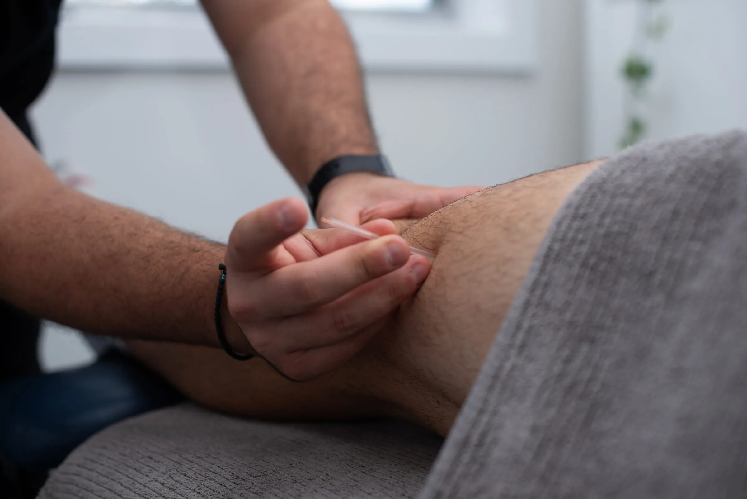Chiropractor assessing a patient's back and shoulders