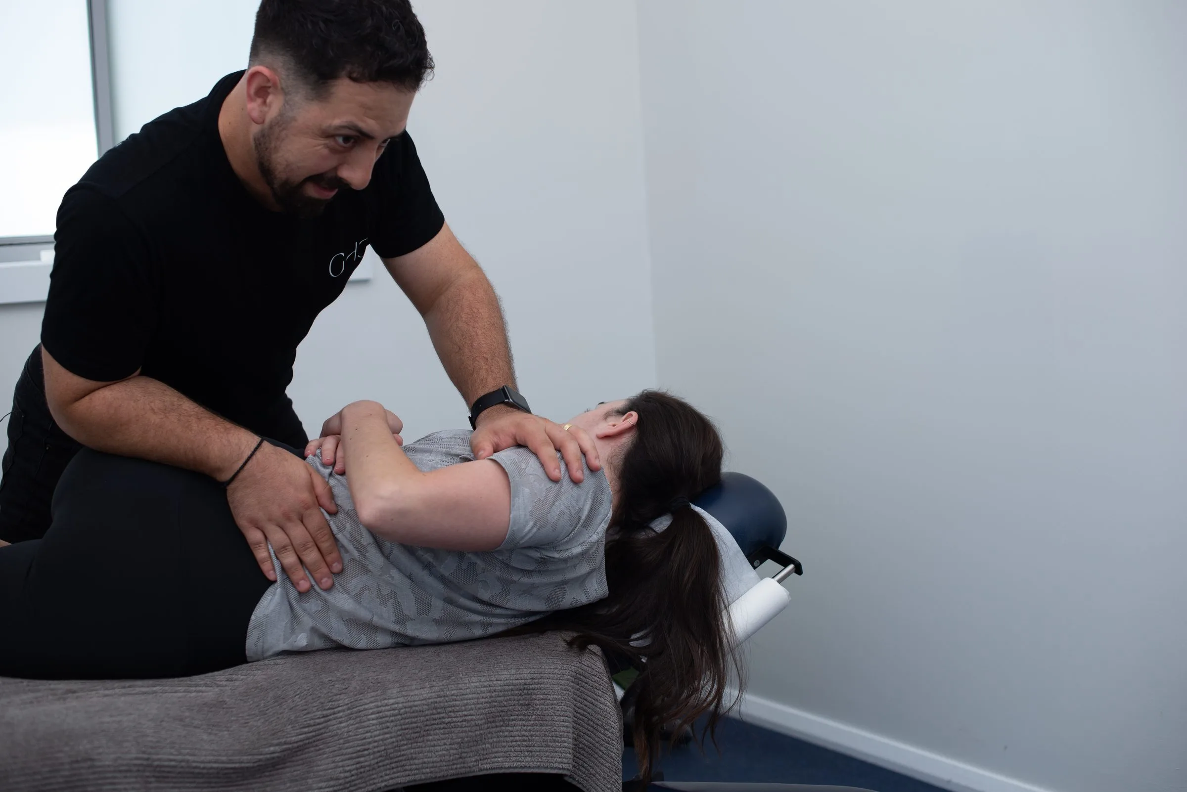 Chiropractor performing an adjustment on a patient at Gladesville Healthcare