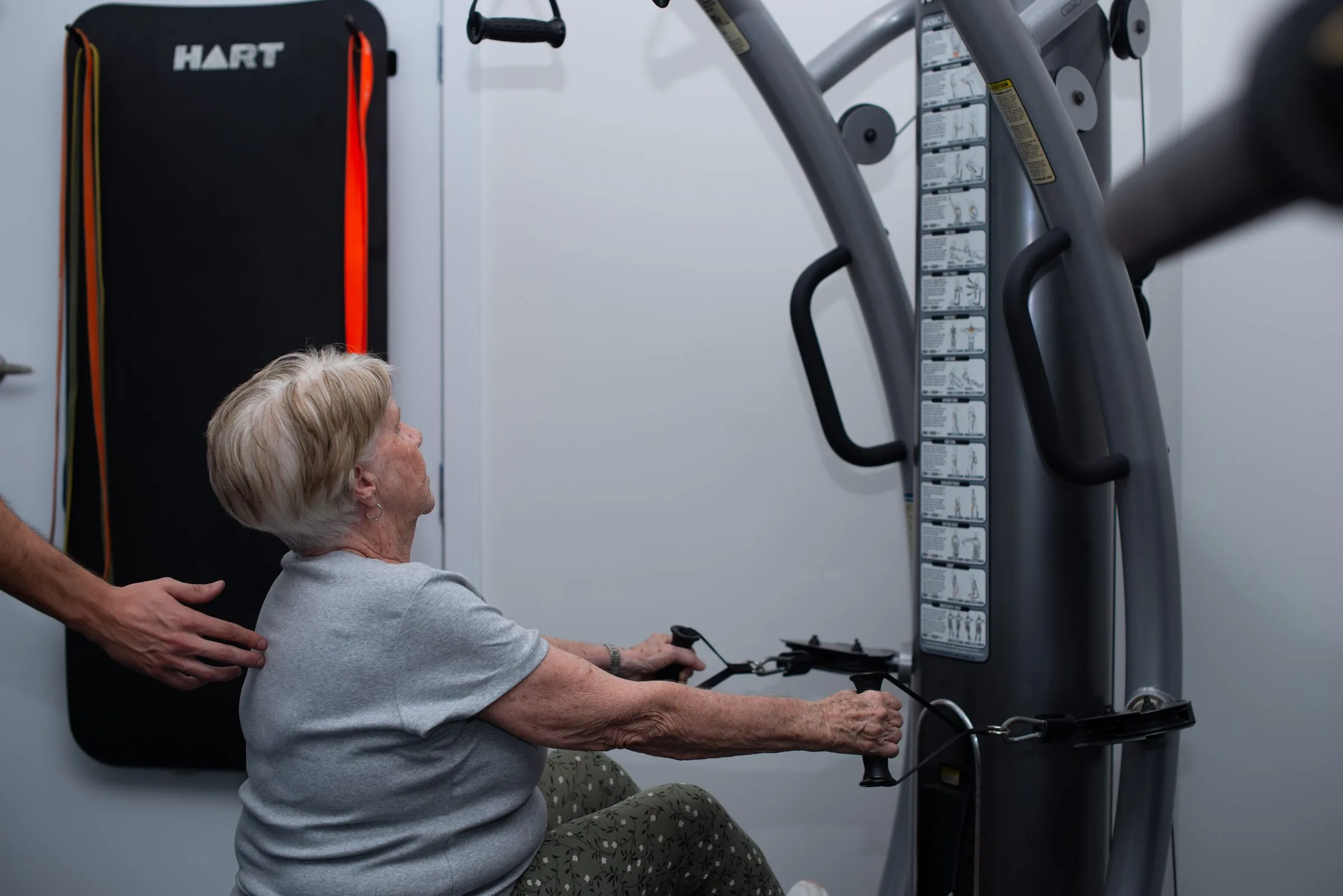 Client working through a supervised strength exercise
