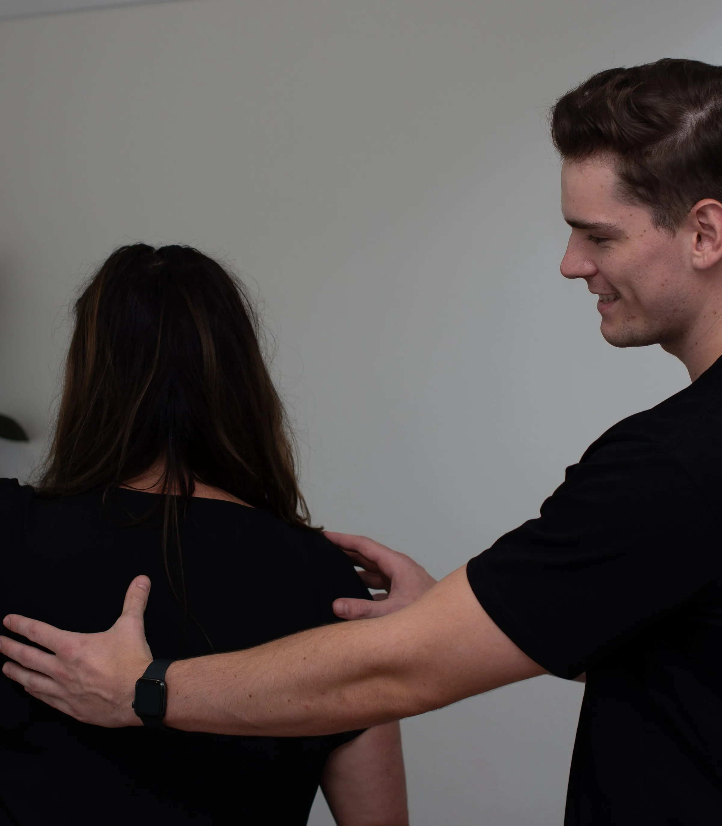 Practitioner treating a patient’s neck in a sunlit room